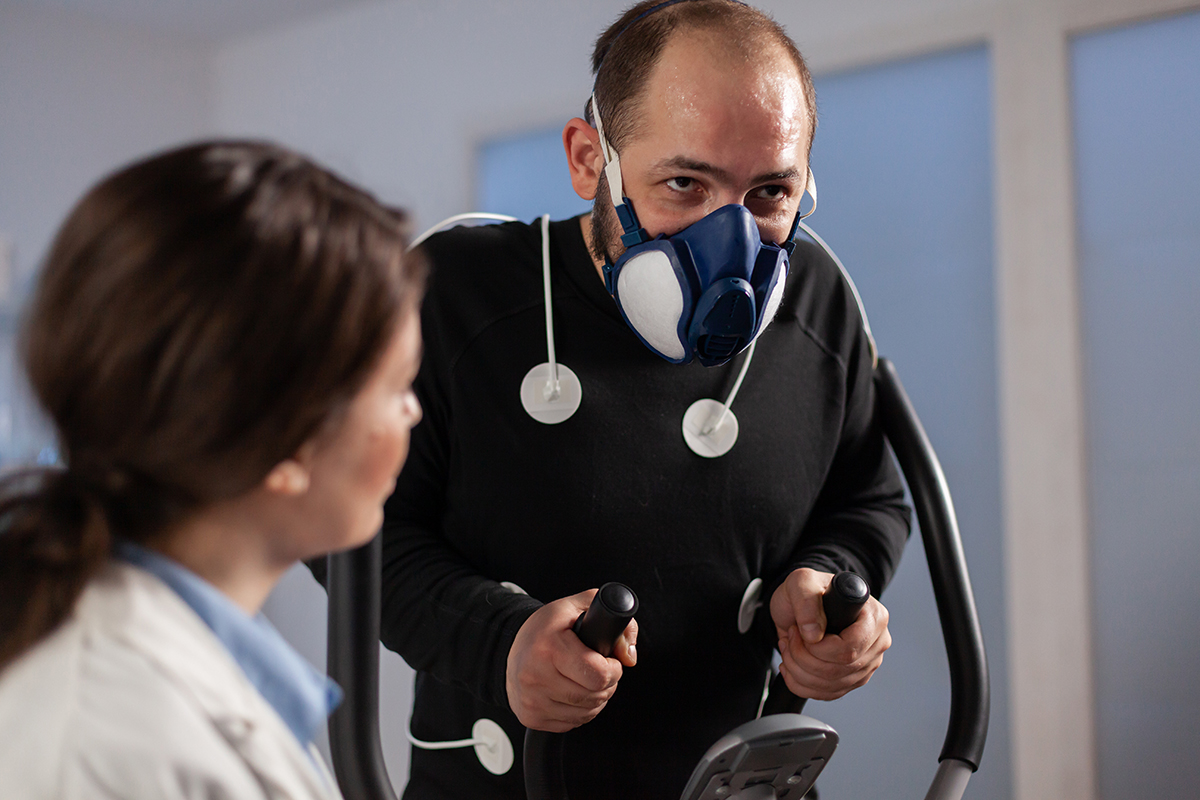 Fitness researcher monitoring performance athlete with sensors Pulmonary pulmonary function testing breathing lungs
