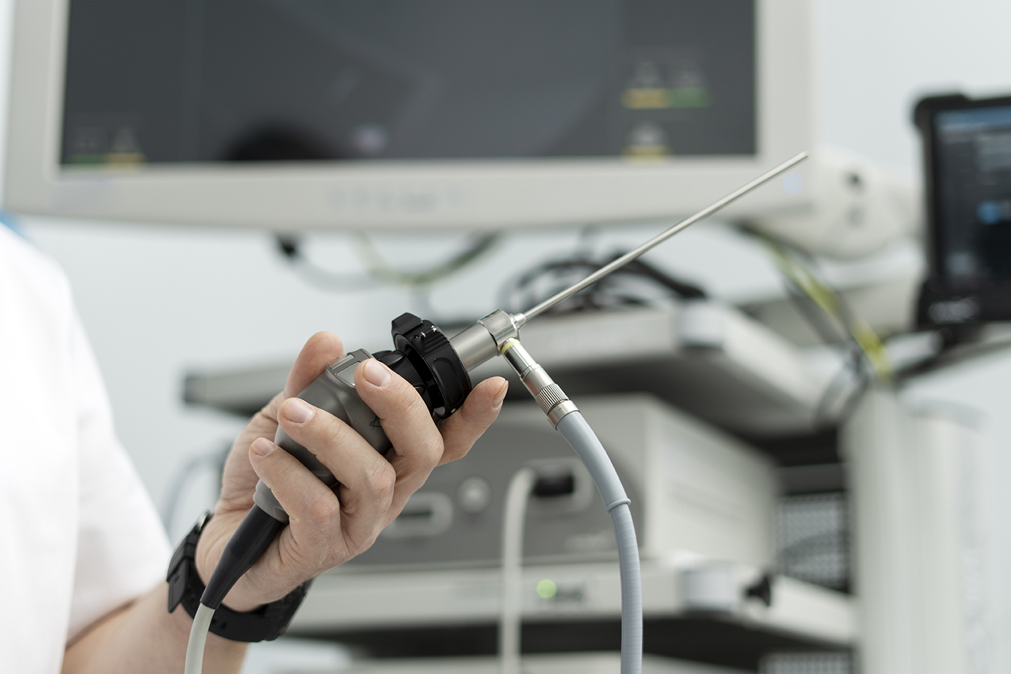 Man holds a medical endoscope, on the background of medical equipment, monitor, selective focus. Detailed health studies, modern technologies in medicine. Man holds a medical endoscope, on the background of medical equipment, monitor, selective focus. Detailed health studies, modern technologies in medicine.