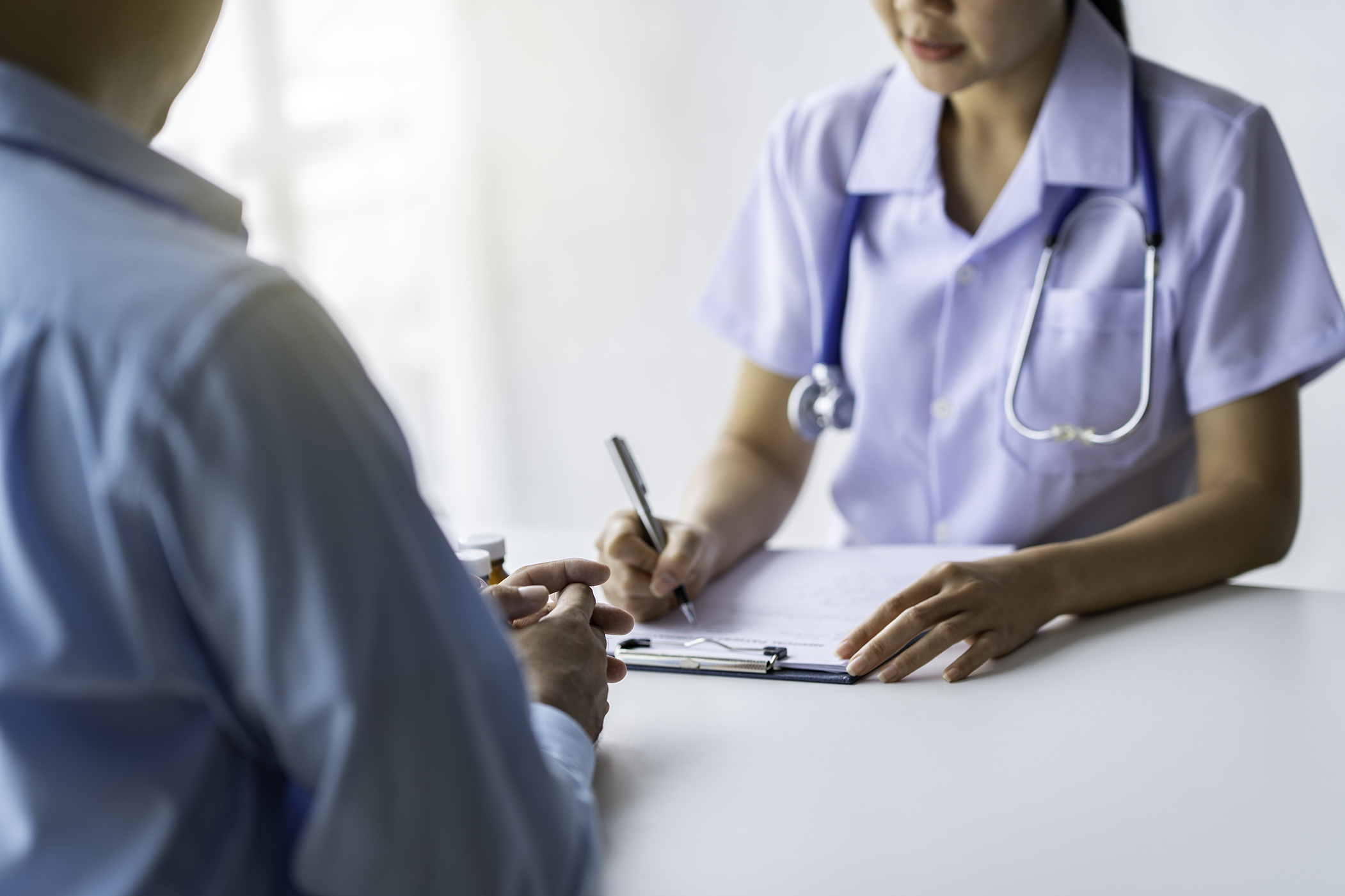 the-doctor-listened-to-the-patient-s-explanation-a-2023-11-27-05-06-19-utc The doctor listened to the patient's explanation and recorded the detailed information in order to analyze the outcome of the treatment plan.