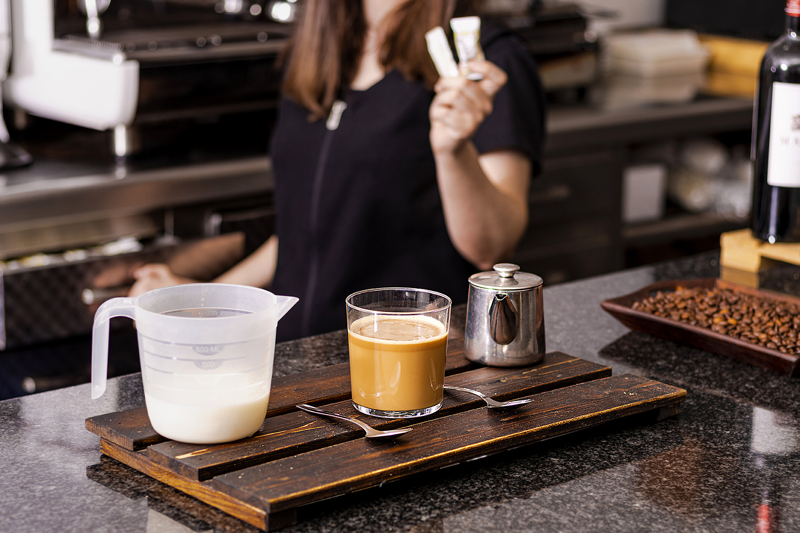 Waitress offering sugar for a cup of coffee Waitress offering sugar for a cup of coffee
