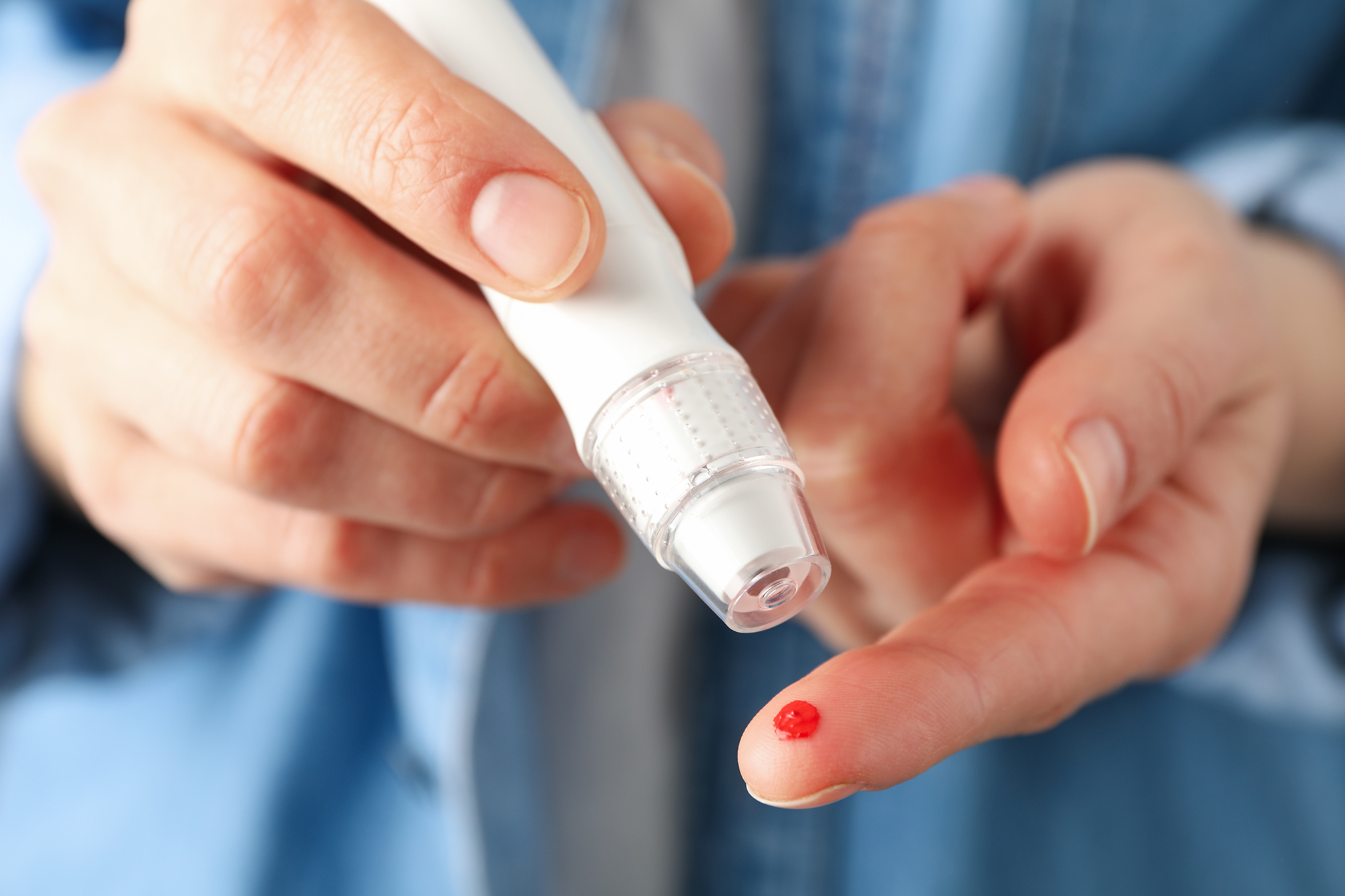 Woman checking blood sugar level, close up Woman checking blood sugar level, close up