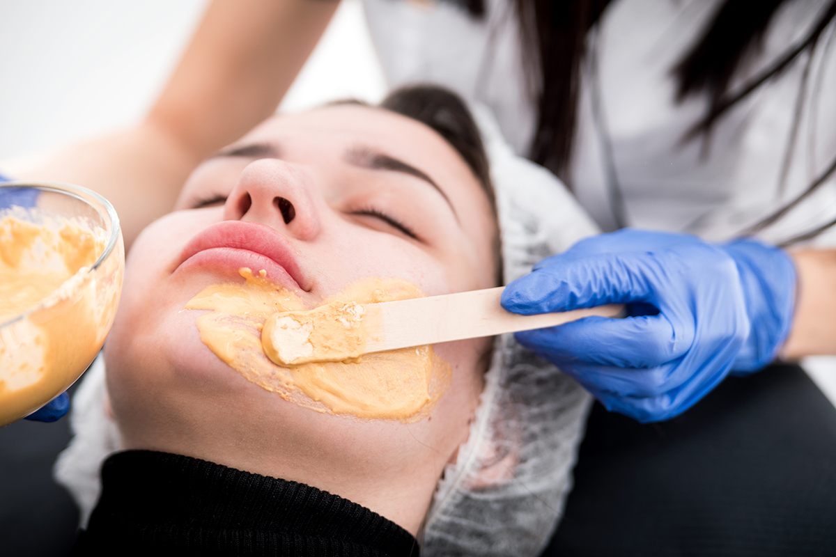 Beautician applying facial mask at cosmetic clinic, cosmetology treatment skincare face Beautician applying facial mask at cosmetic clinic, cosmetology treatment skincare face