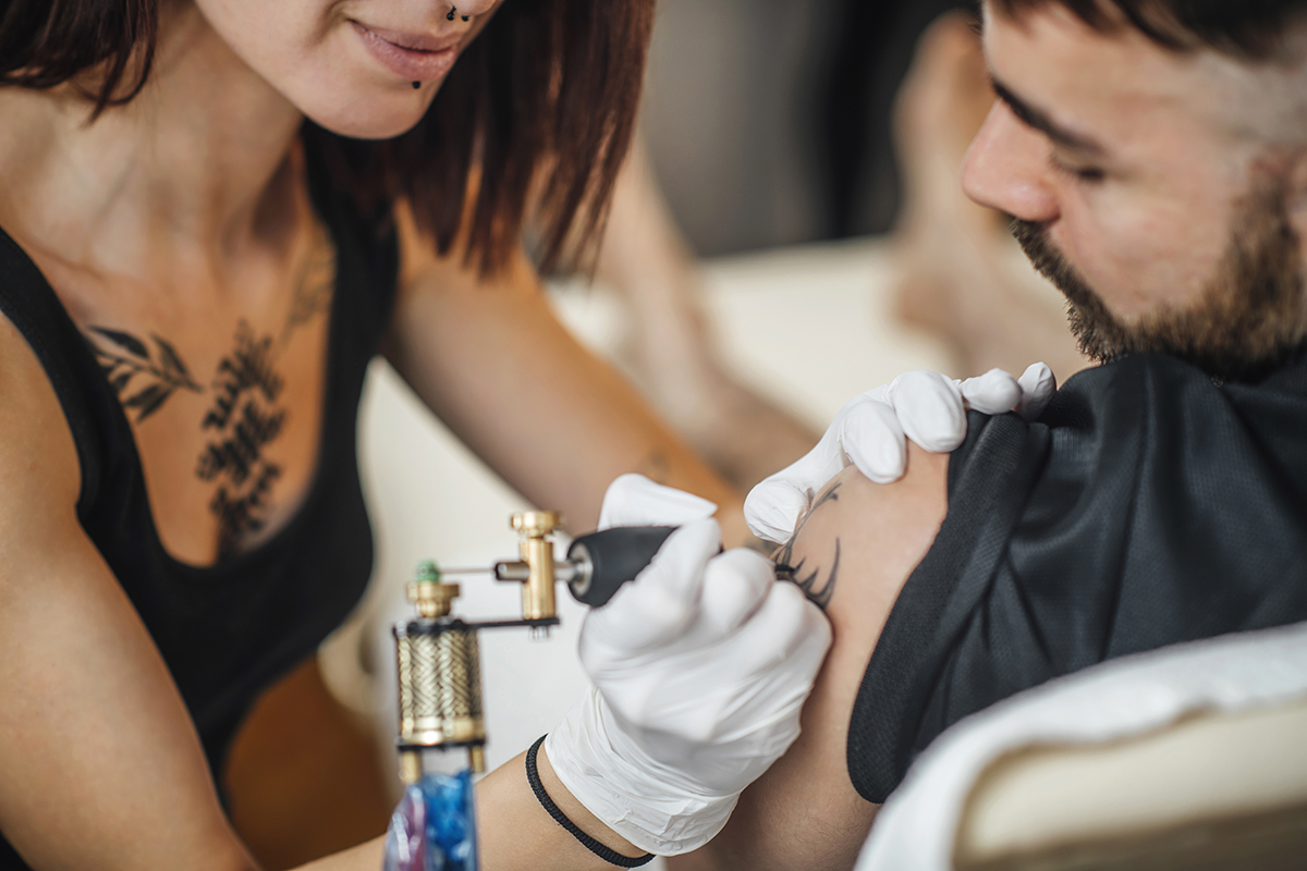 Tattooing process in a tattoo studio